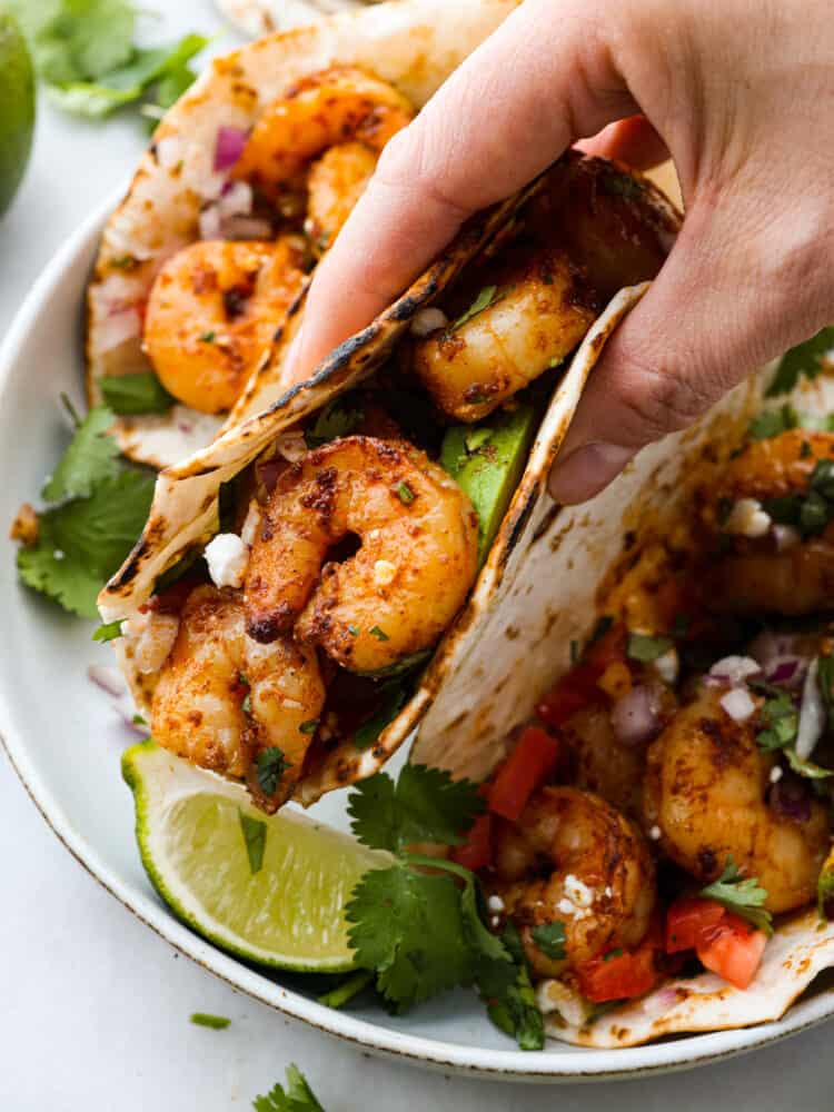 A shrimp taco being picked up.