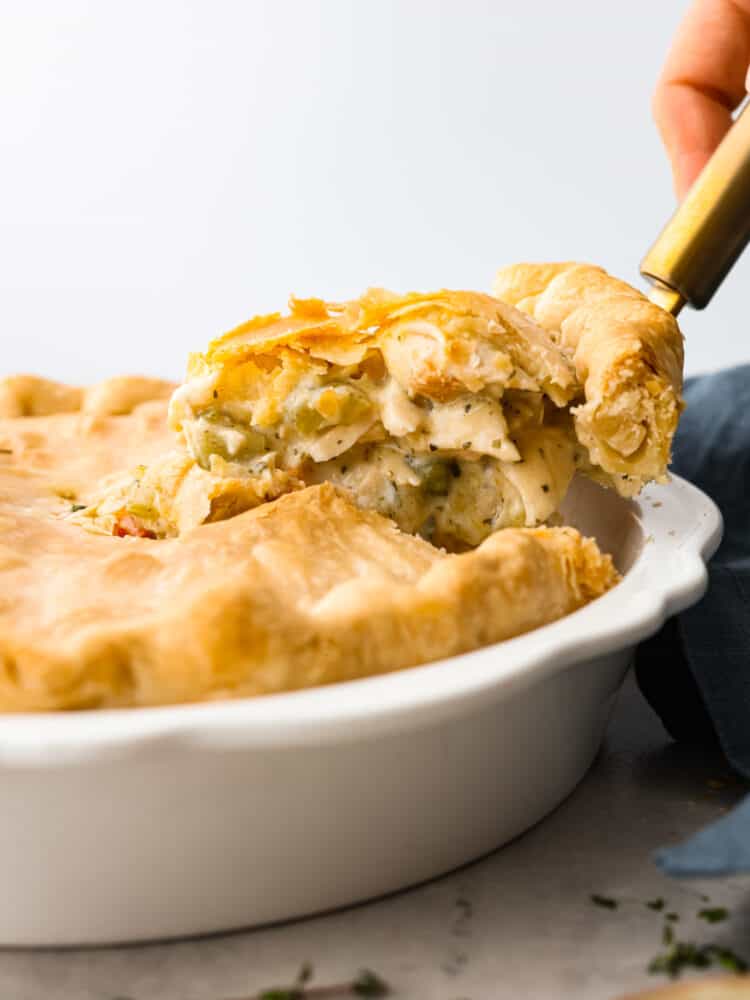 A slice being lifted out of the pie dish with a spatula.