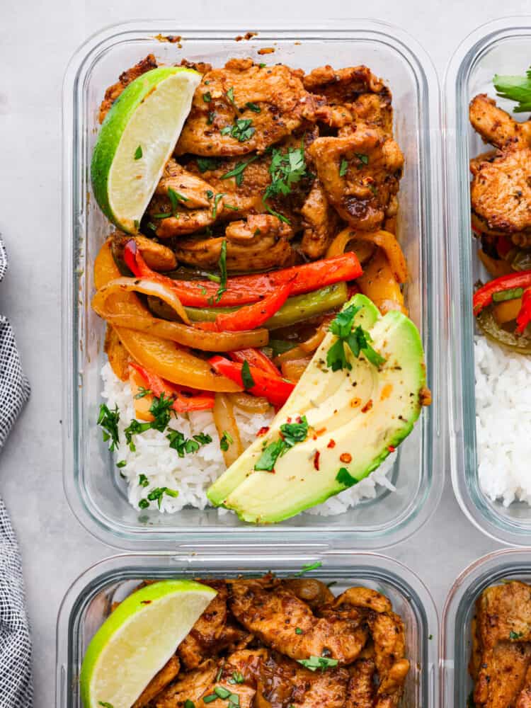 Chicken fajita meal prep bowls with rice and peppers.