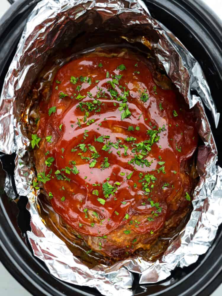 Top-down view of cooked meatloaf in a crockpot.