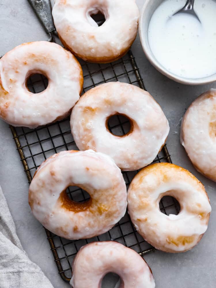 Delicious glazed donuts with glaze in a bowl.
