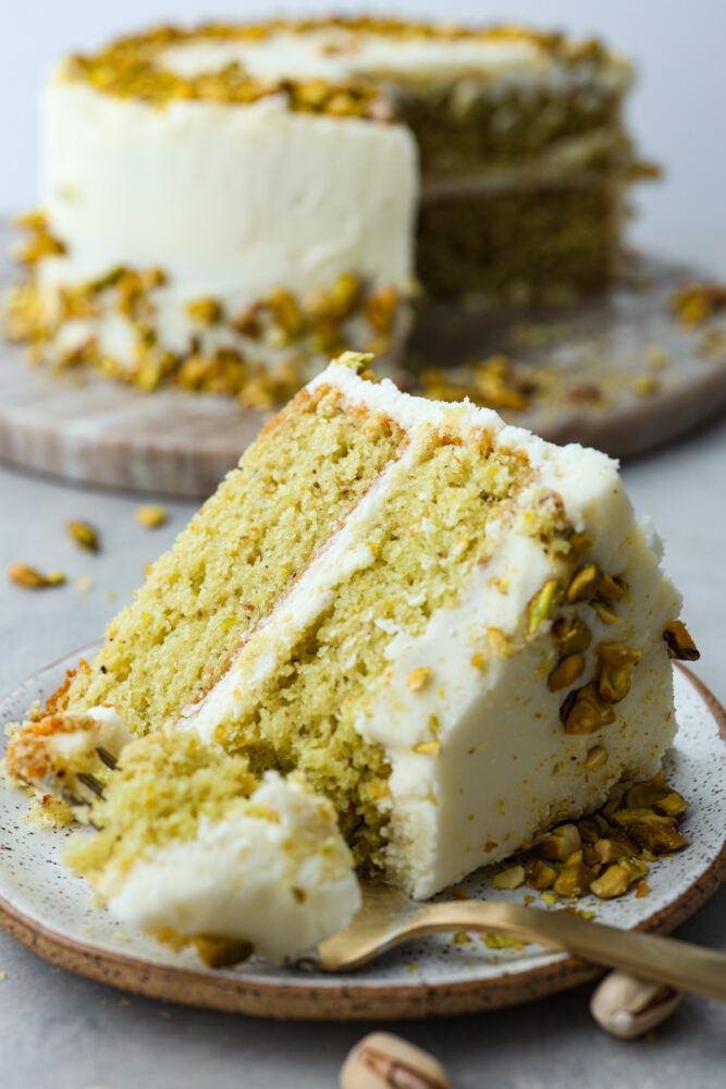 A slice of pistachio cake on a plate.
