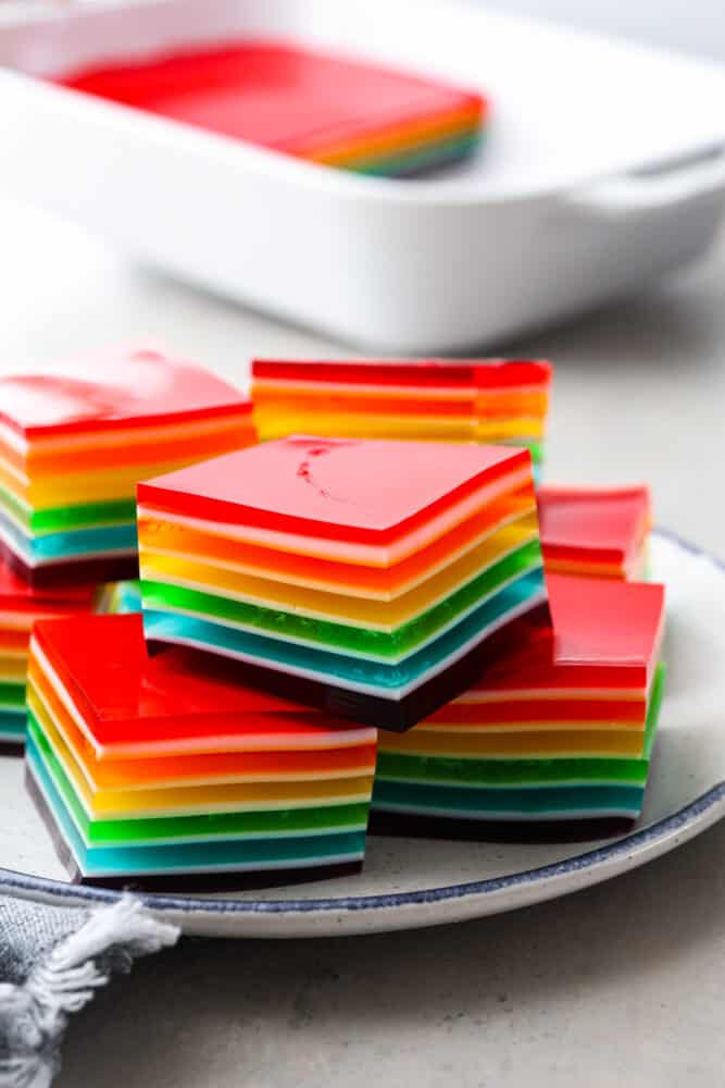 Cubed rainbow jello stacked on top of each other.