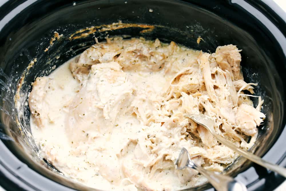 Shredding chicken in a crock pot.