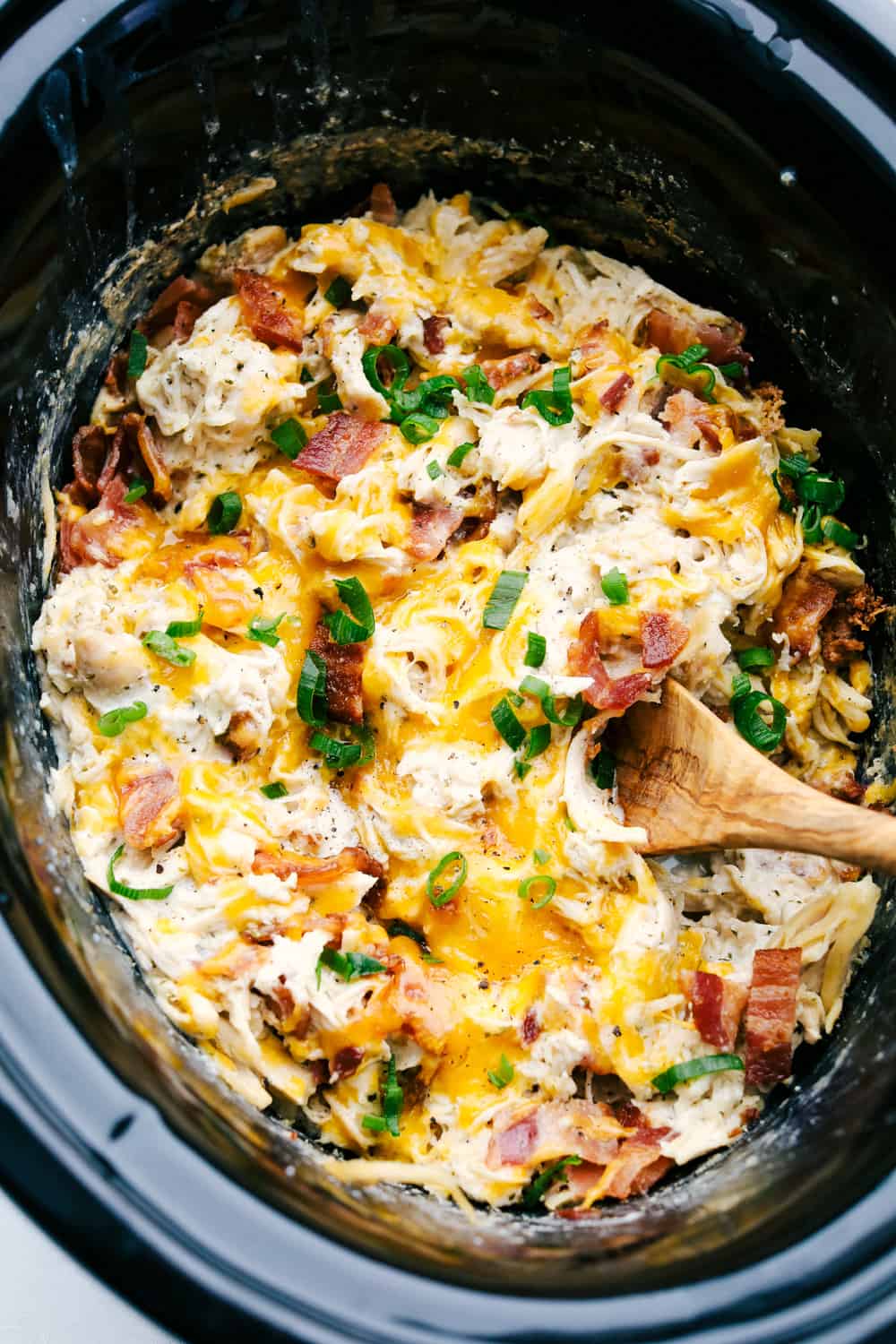 Close up of creamy, rich and addicting Slow Cooker Crack Chicken with cheddar, bacon and ranch.