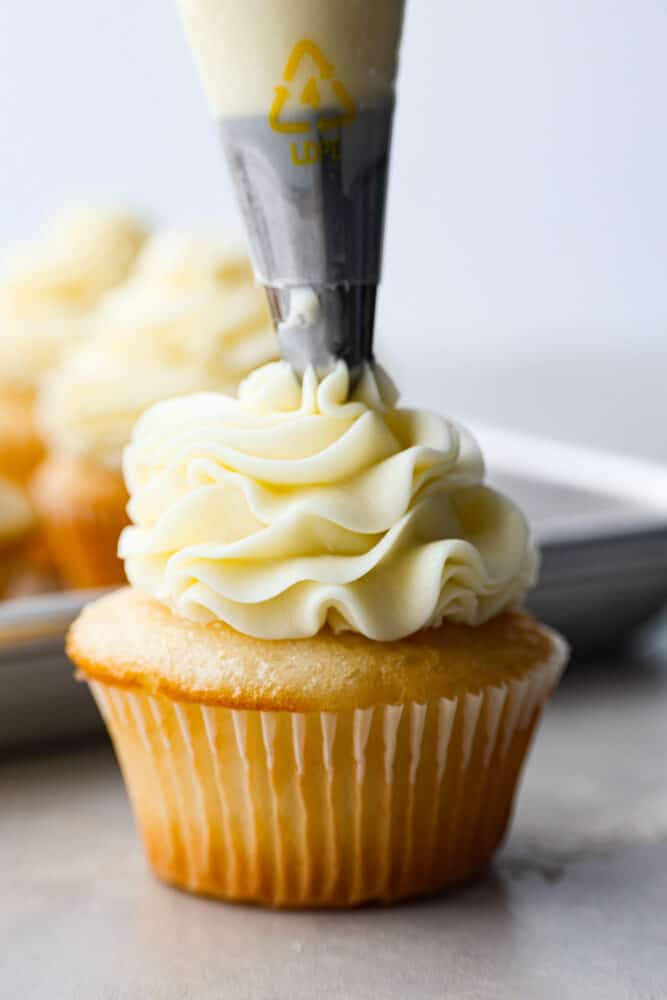 A cupcake being frosted.