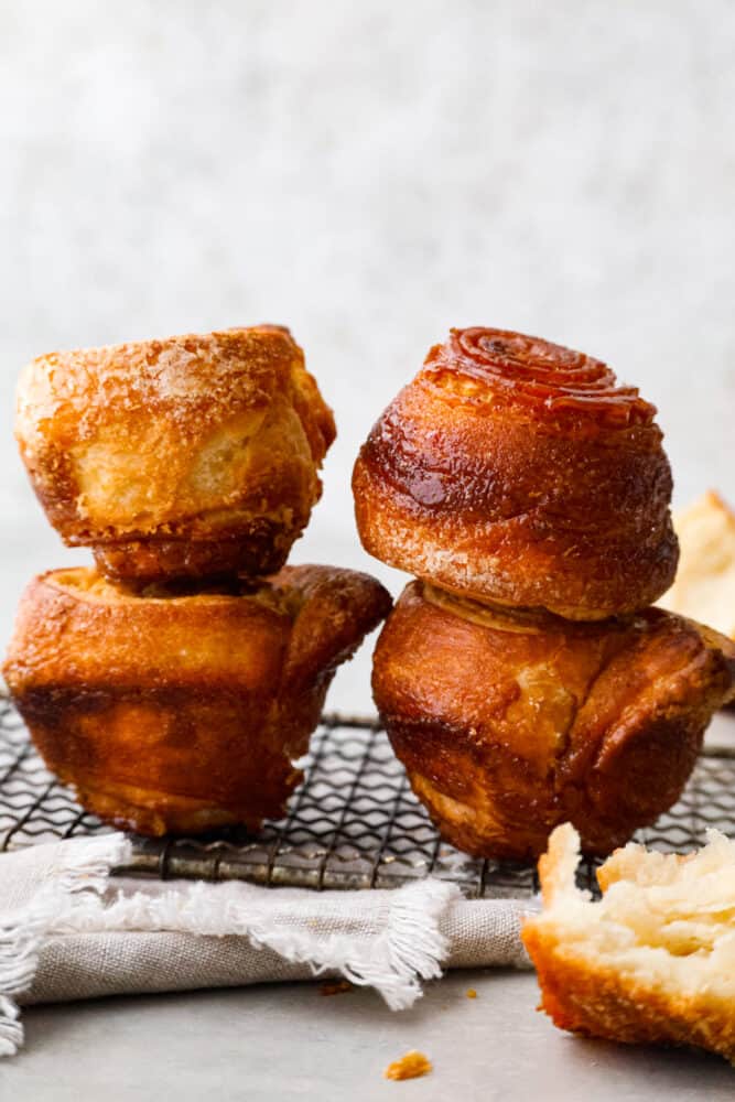 A side view of kouign amman stacked on top of each other.