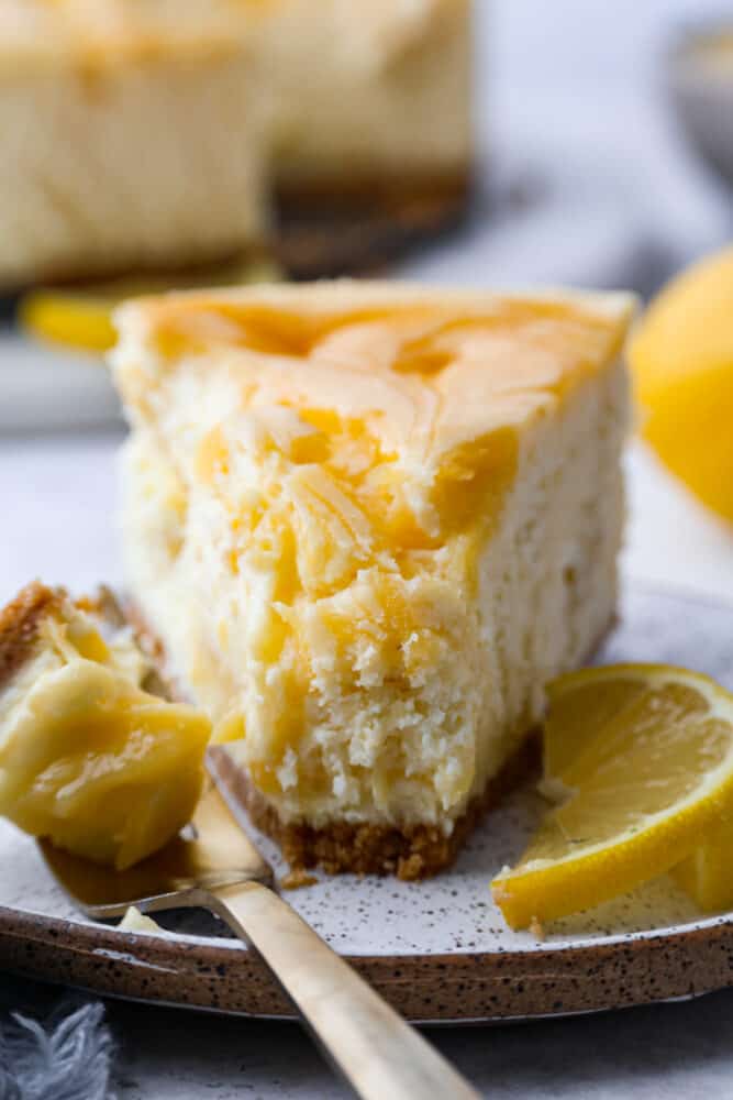Front view of a slice of lemon cheesecake.