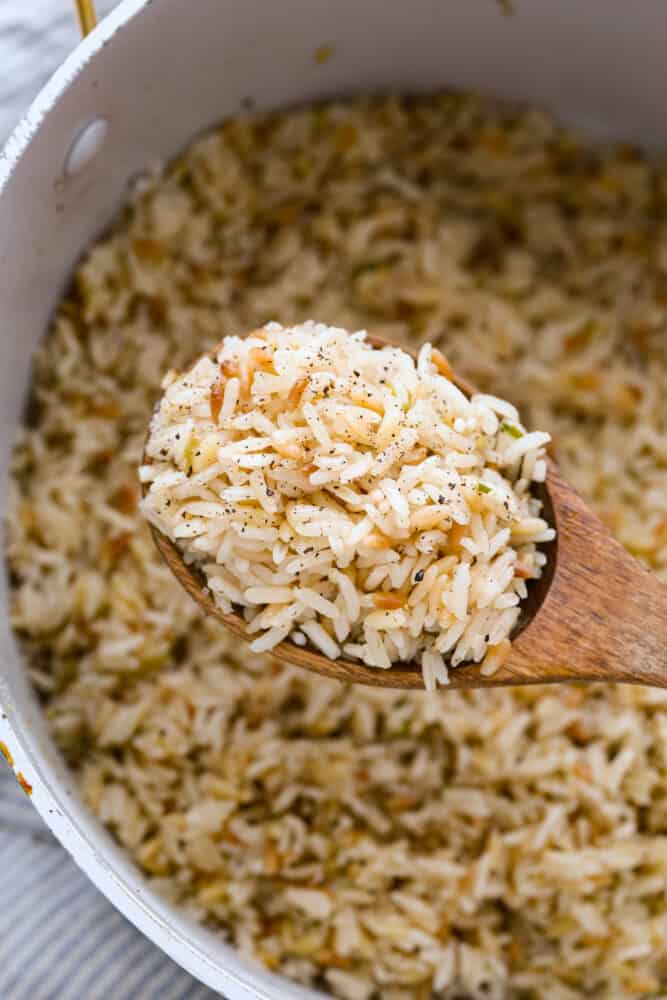 Closeup of a spoonful of seasoned rice and orzo.