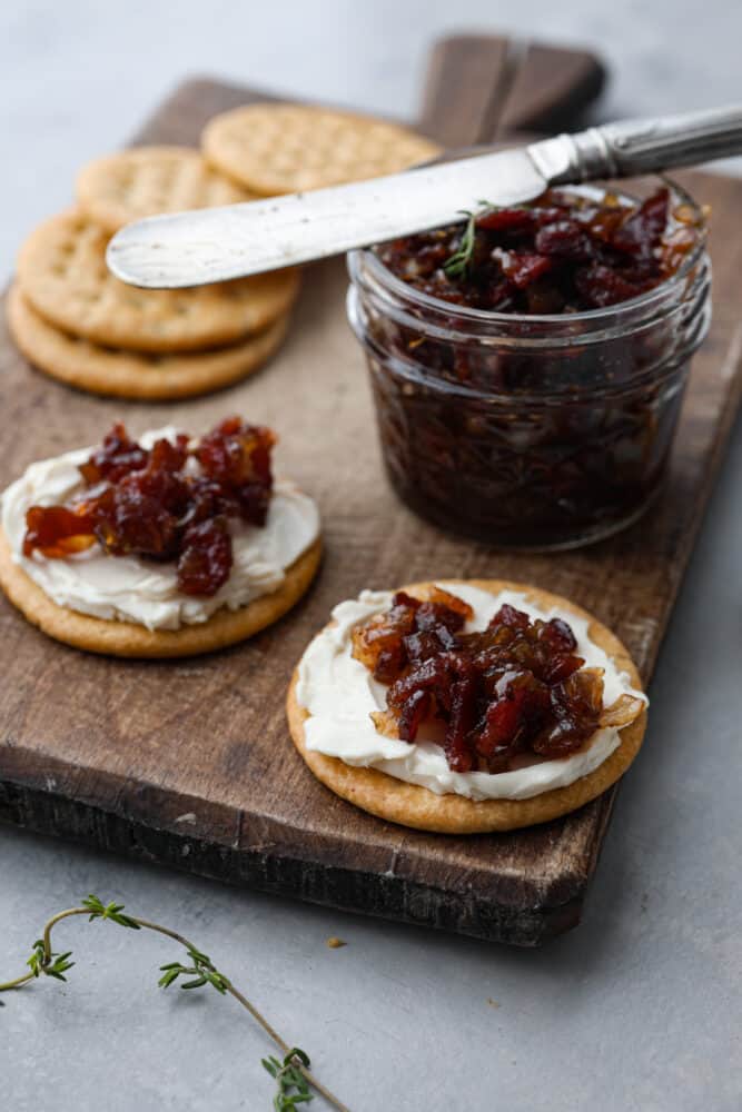 Bacon jam and cheese spread on 2 crackers.