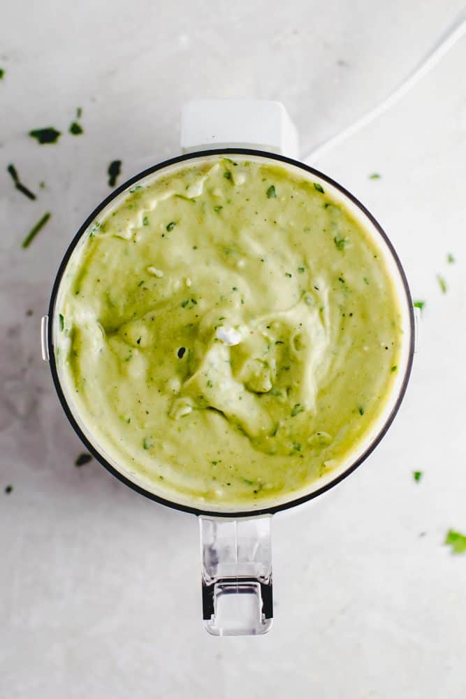 Avocado cream sauce being blended together. 