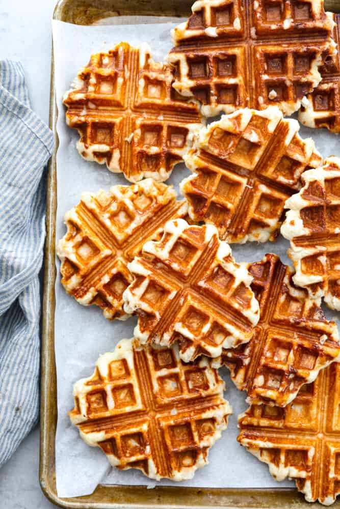 Liege waffles on a sheet pan lined with parchment.