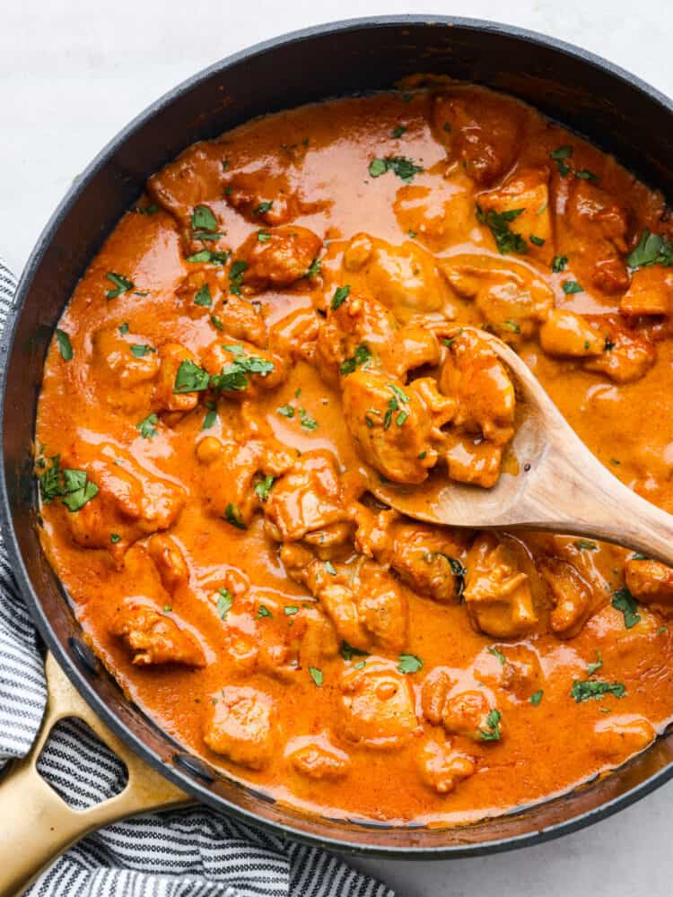 Top-down view of butter chicken in a skillet.
