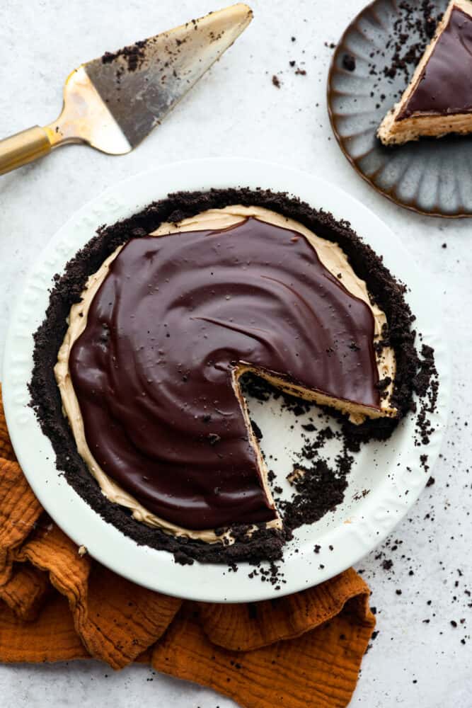 Top-down view of chocolate peanut butter pie with a slice cut out of it.