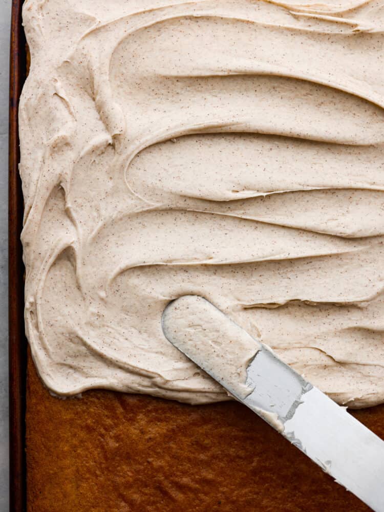 The top view of a sheet cake with cinnamon cream cheese frosting. 