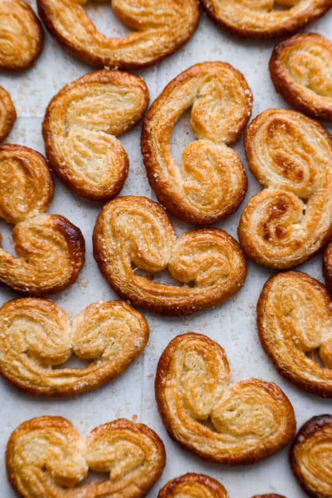 Top-down view of palmiers on parchment paper.