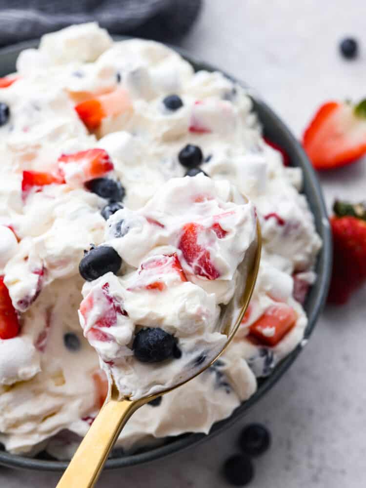 A spoonful of red white and blue cheesecake salad.