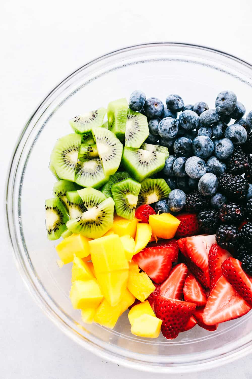 Fruit salad ingredients in a bowl before they are mixed.