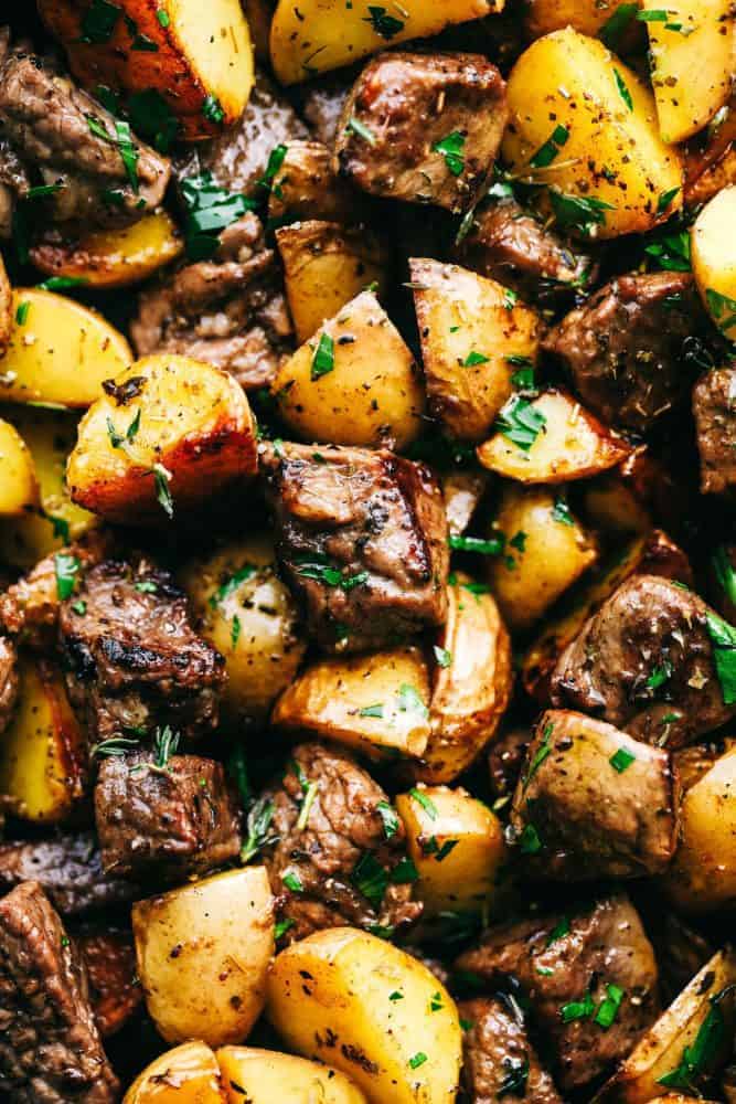 Close up of Garlic Butter Herb Steak Bites with Potatoes. 