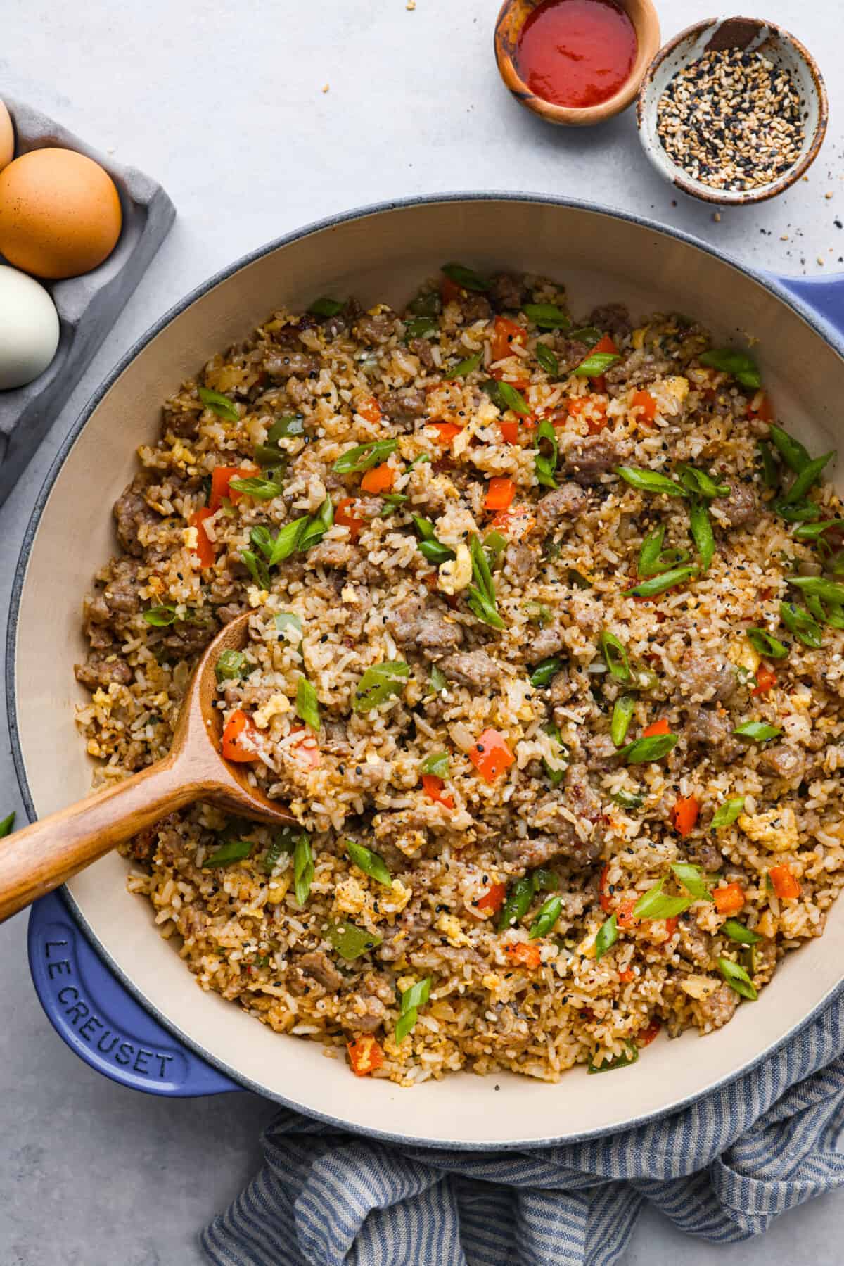 A pan of breakfast fried rice with a wooden spoon. 