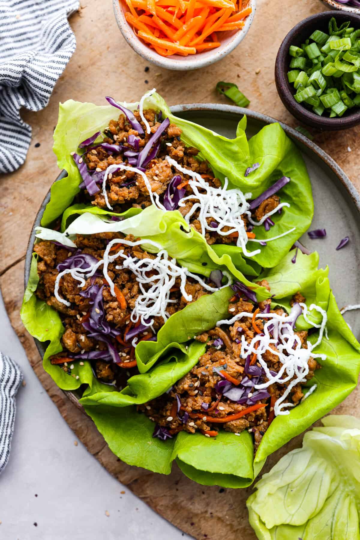 Top-down view of lettuce wraps on a gray plate.
