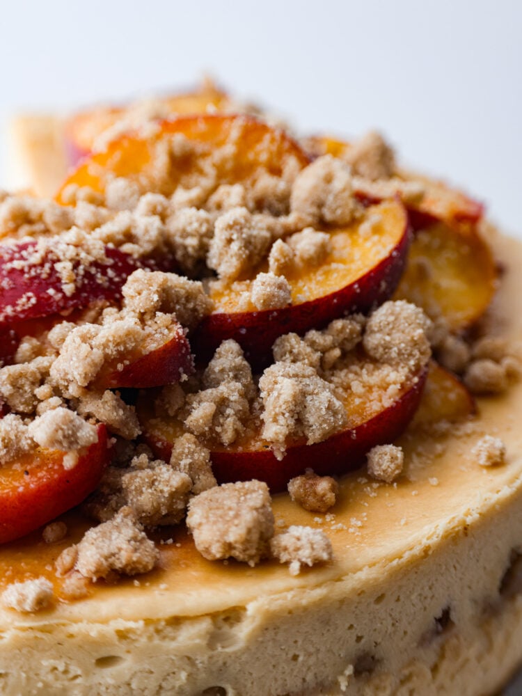 Streusel topping on peach cobbler cheesecake.
