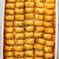 Crispy tater tots lined up on top of a cowboy casserole.