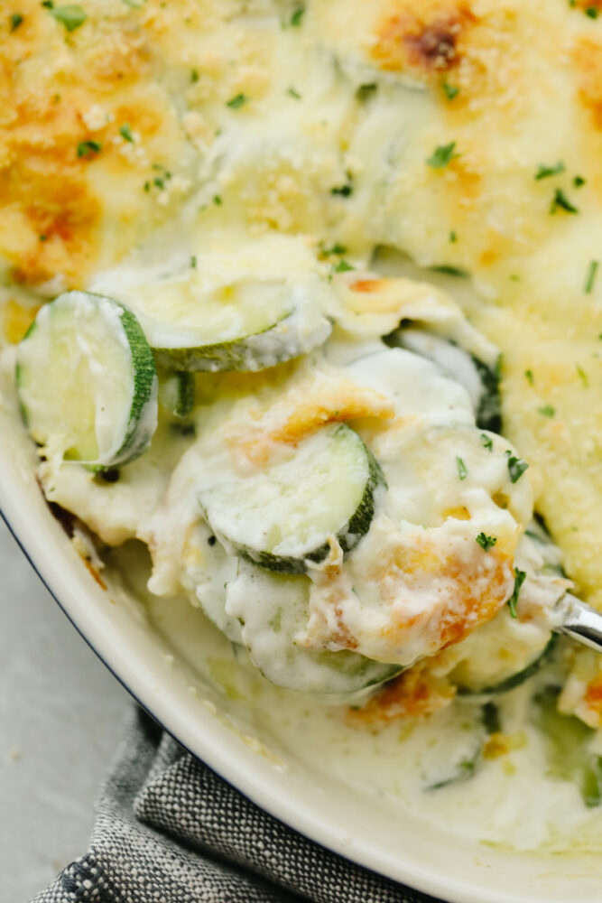 Taking a scoop of Parmesan Zucchini Gratin.
