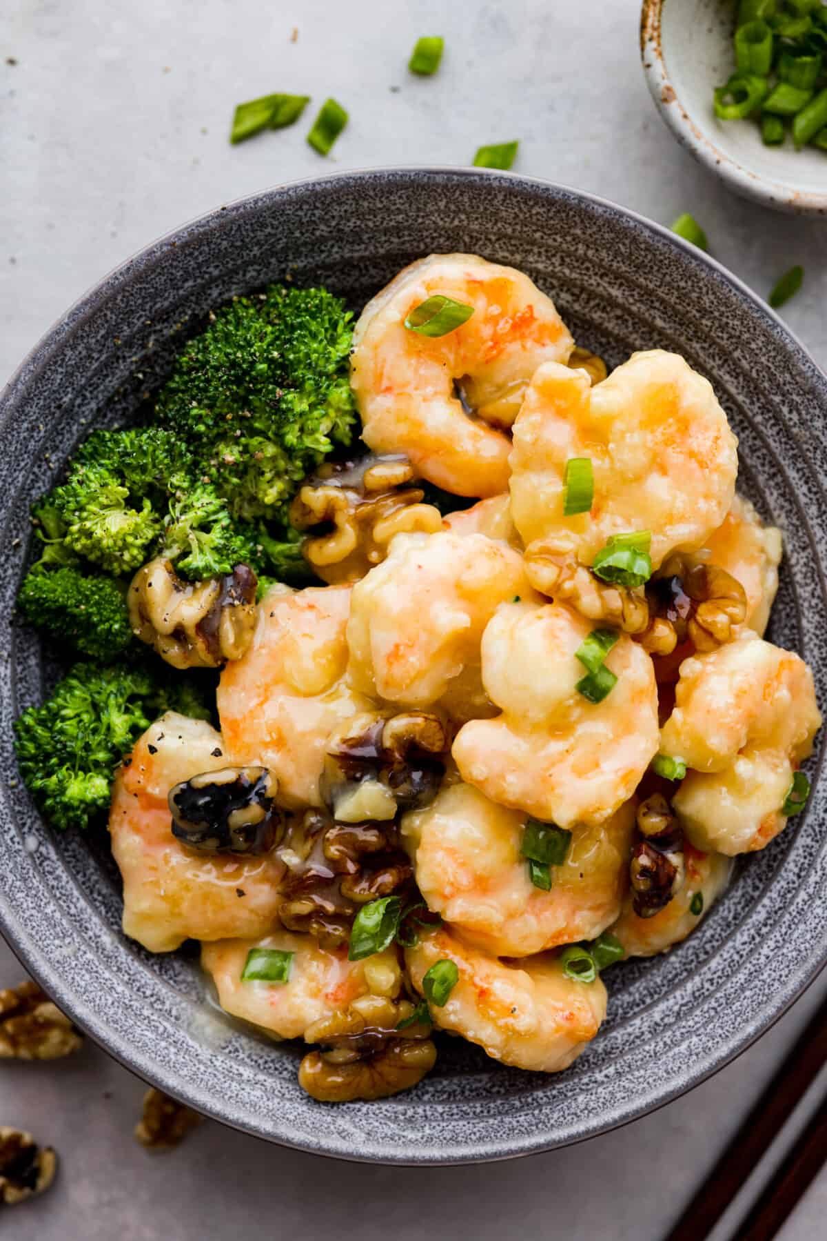 Shrimp served with broccoli in a gray bowl.