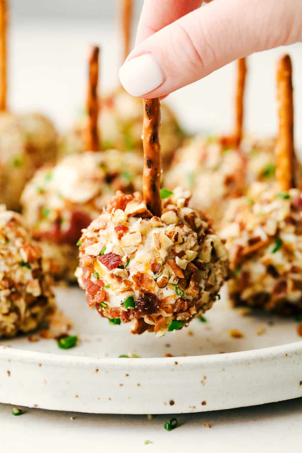 Bacon ranch cheese ball bites with a pretzel on top. 