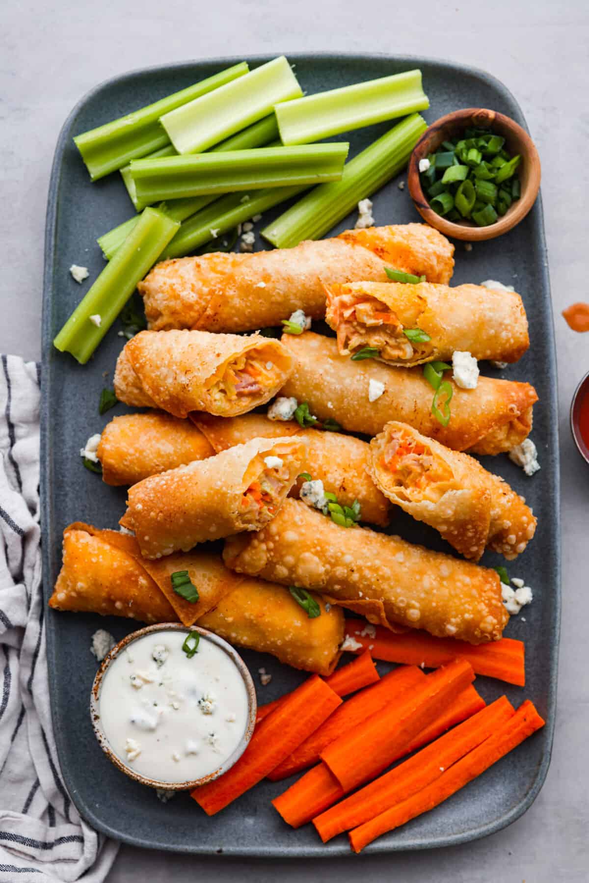 The top view of cooked egg rolls on a platter. 
