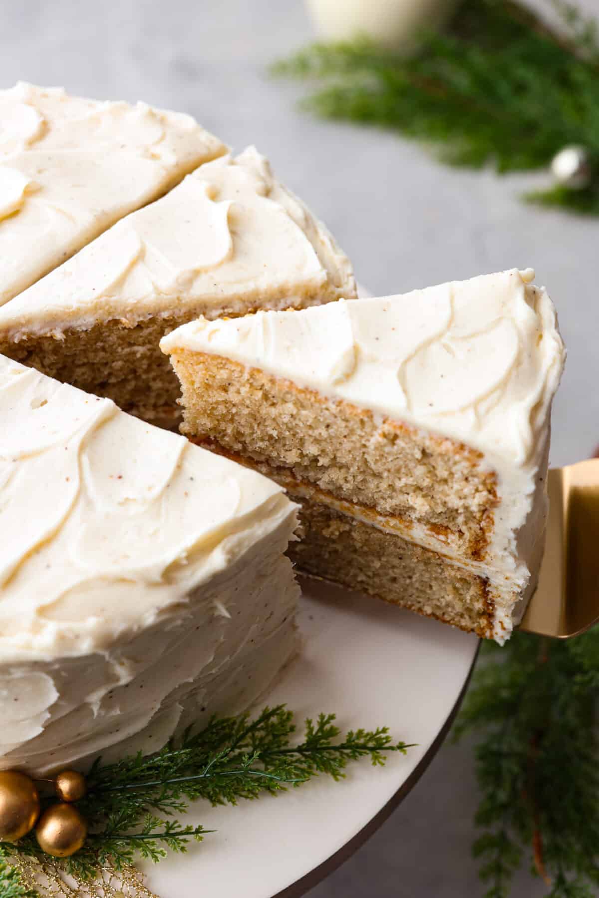 Top side view of a slice of eggnog cake on a cake spatula.