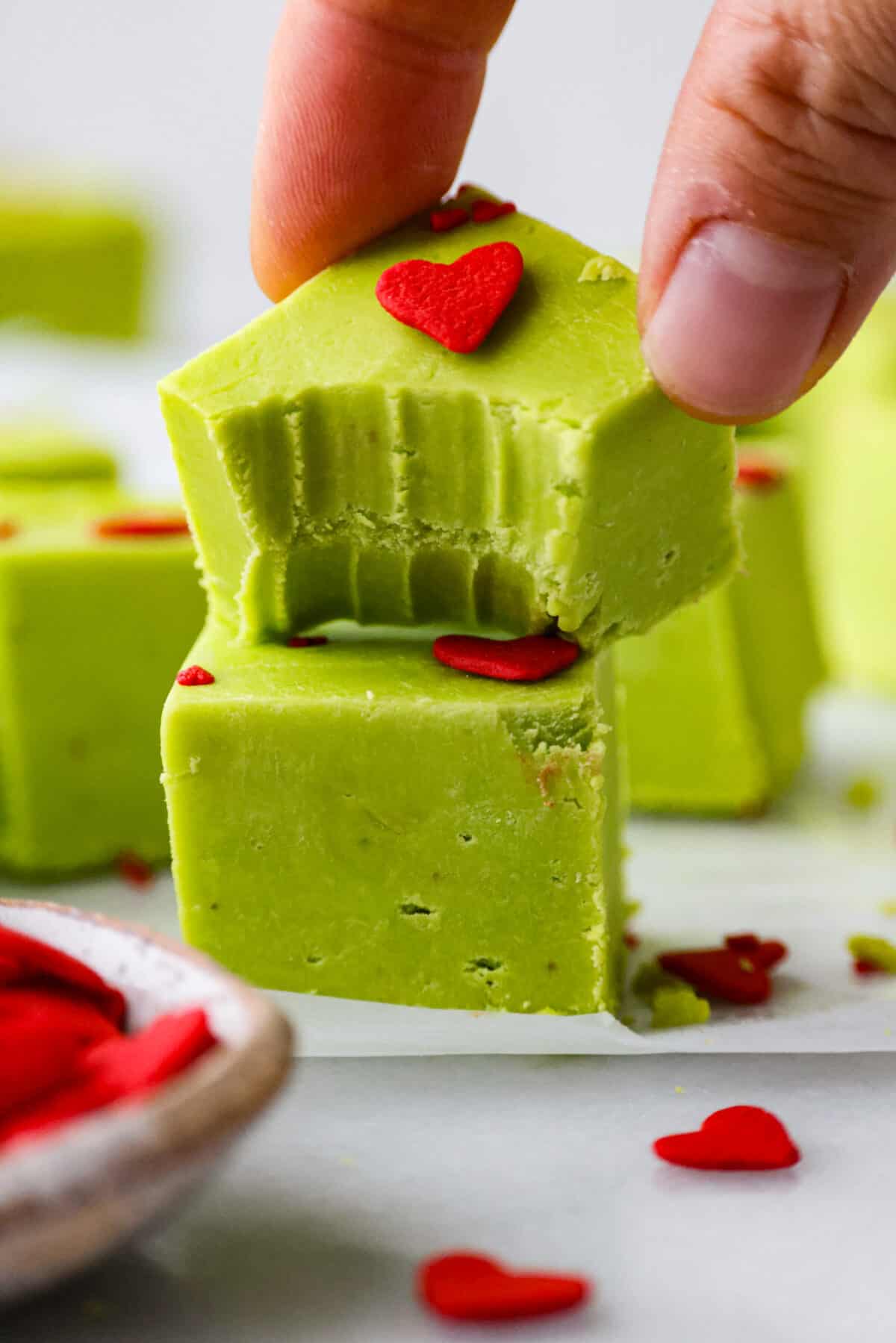 A piece of Grinch fudge with a bite taken out of it. 
