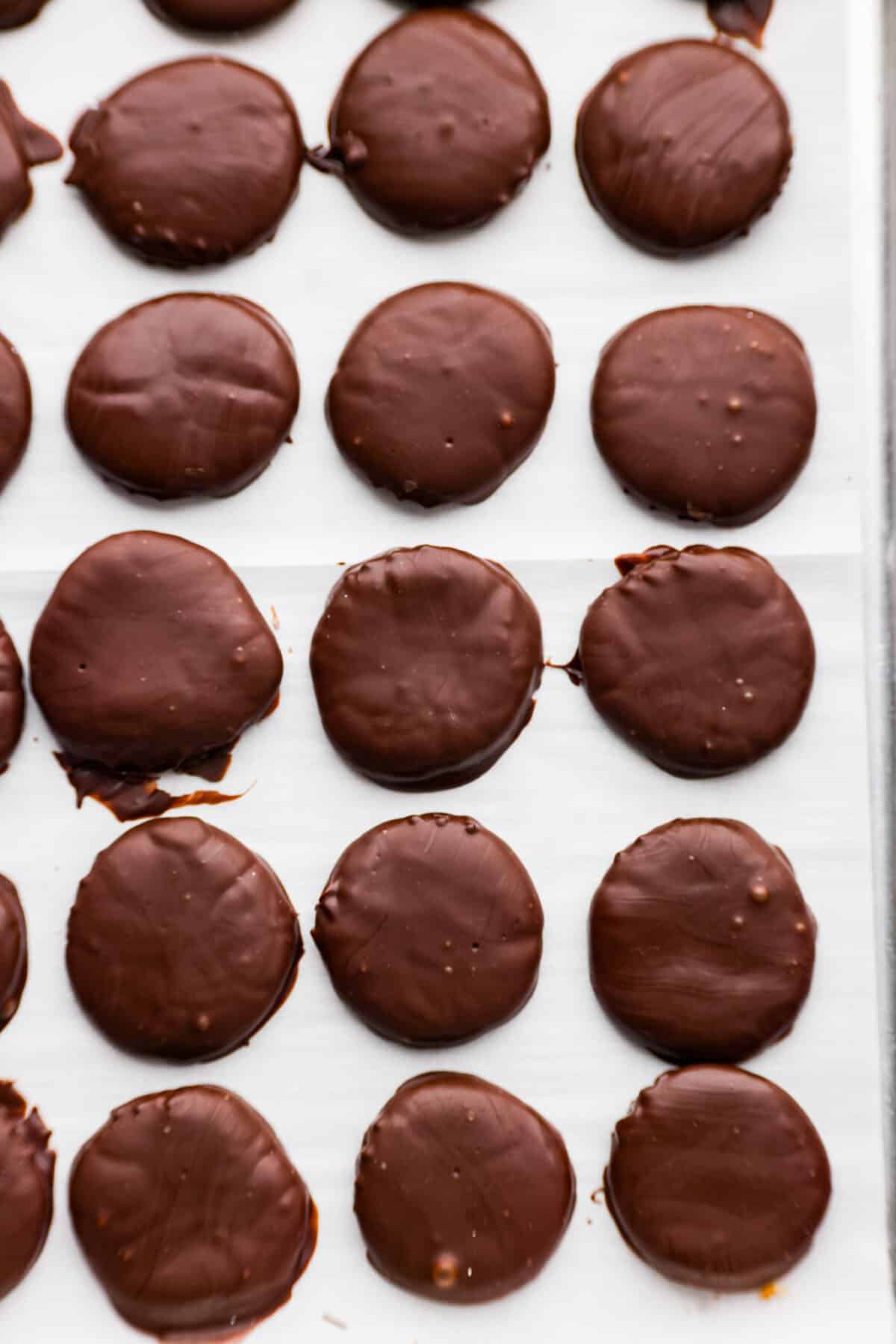 Top-down view of peppermint patties on parchment paper.