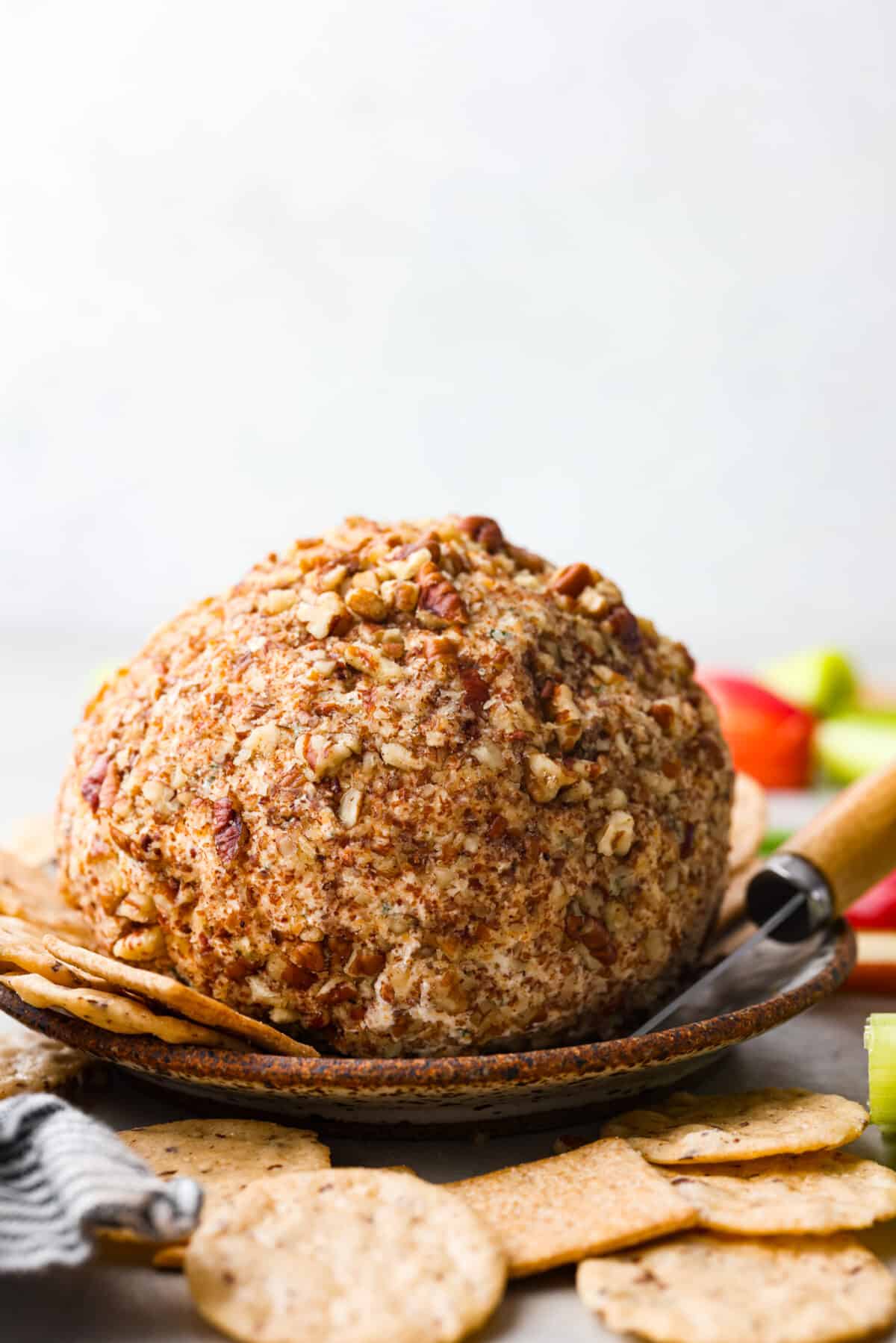 A cheese ball, coated in pecans.