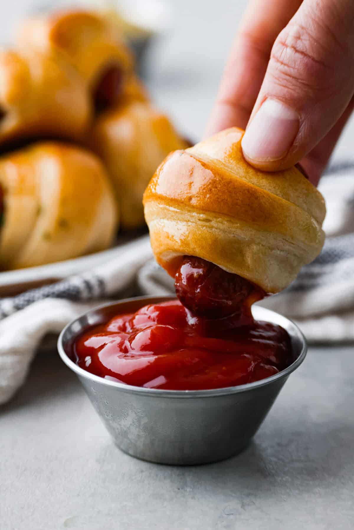 Closeup of one of them being dipped into ketchup.