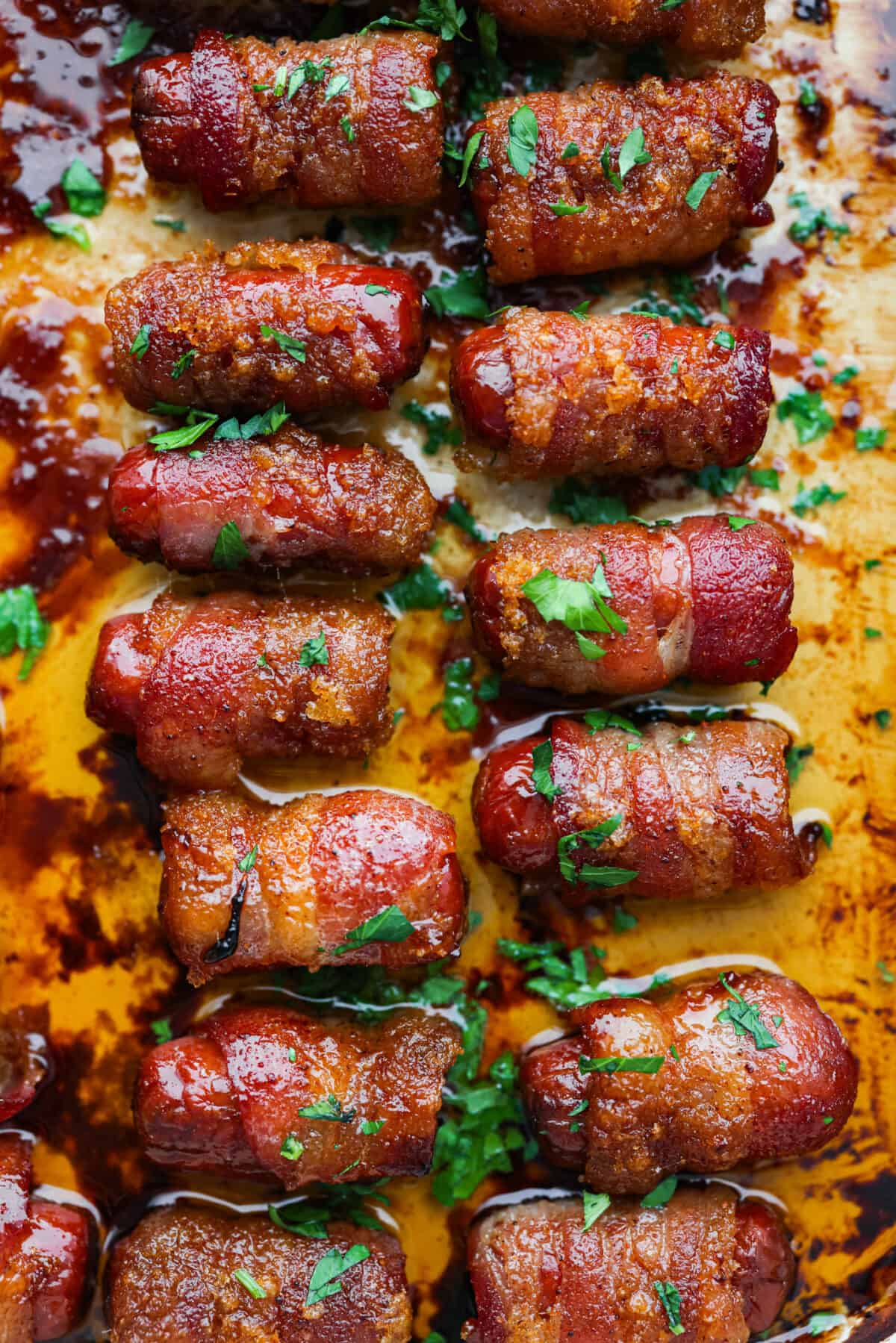 Top view of bacon wrapped smokies in a baking dish.