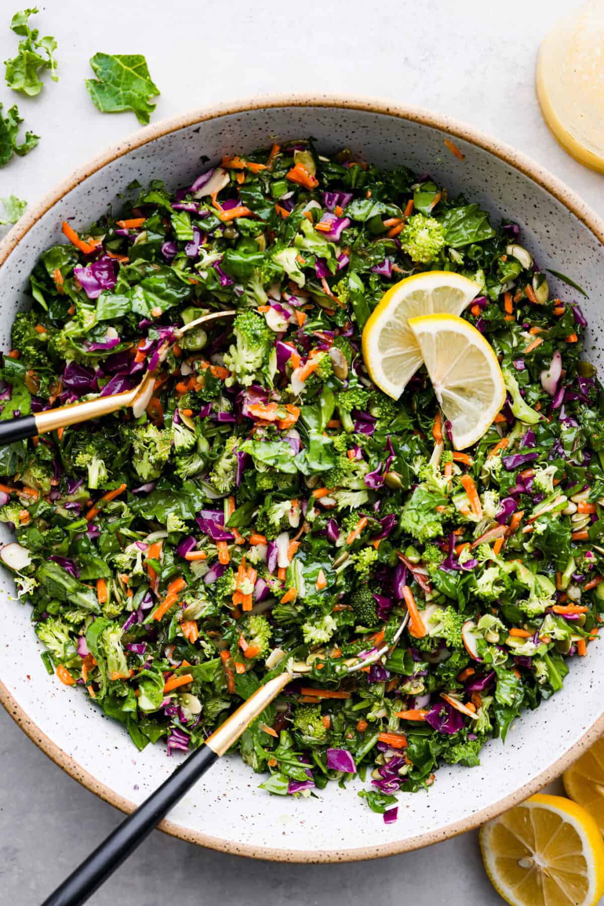 Overhead view of detox salad in a large bowl with a serving spoon.