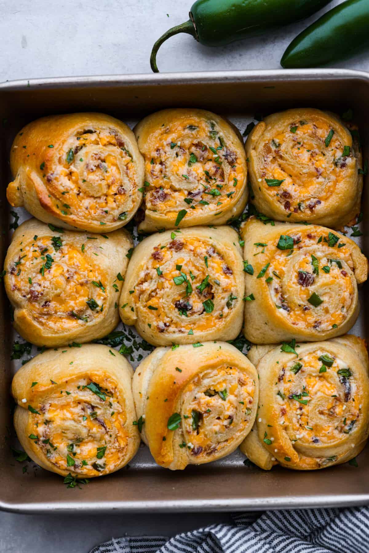 Top view of jalapeno popper rolls baked in a pan.