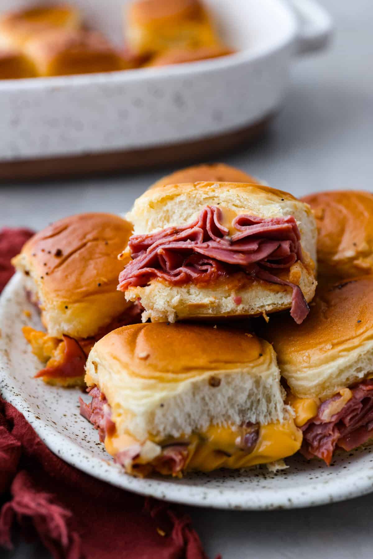 Beef and cheddar sliders served on a plate.