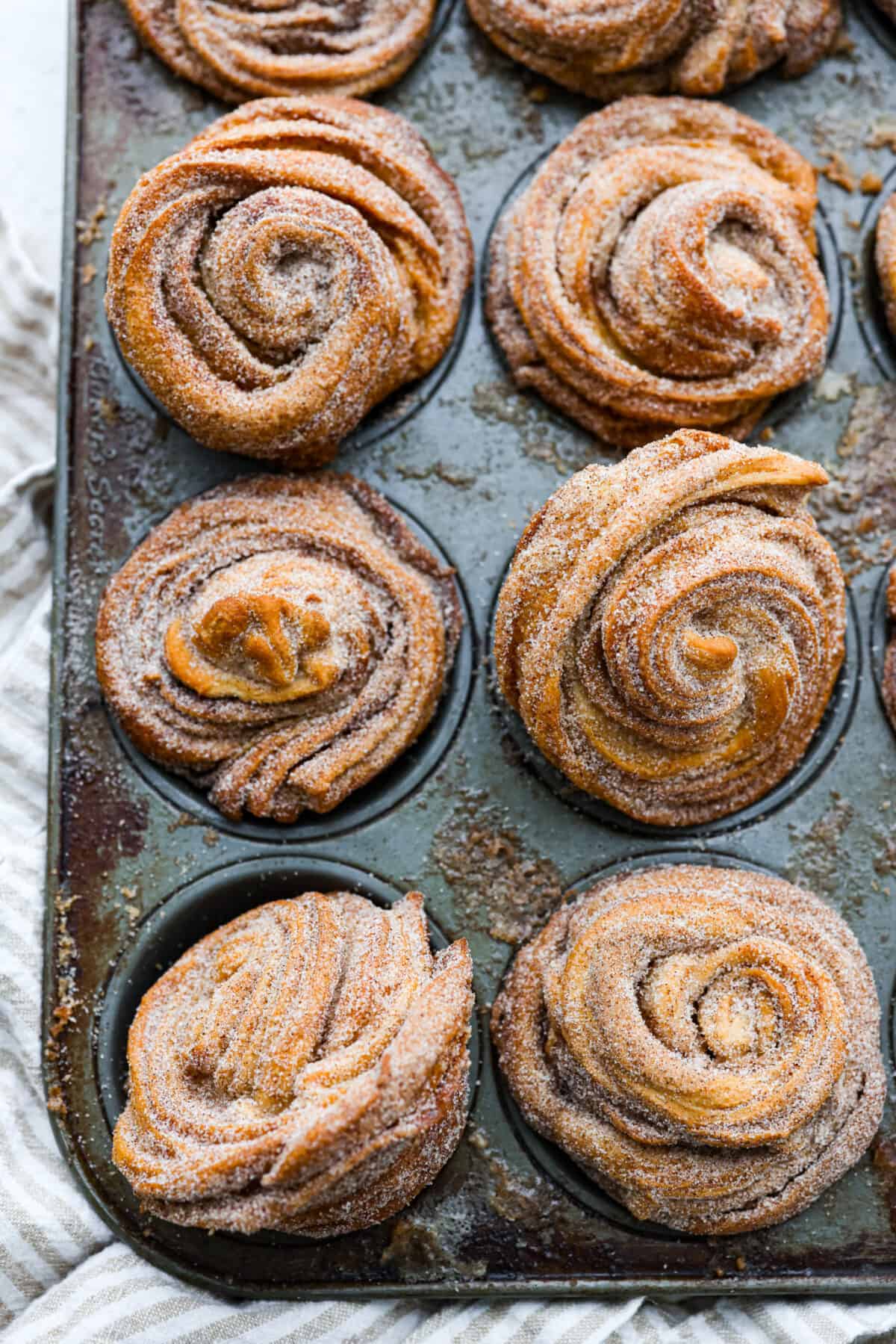 Baked cruffins in a muffin tin.