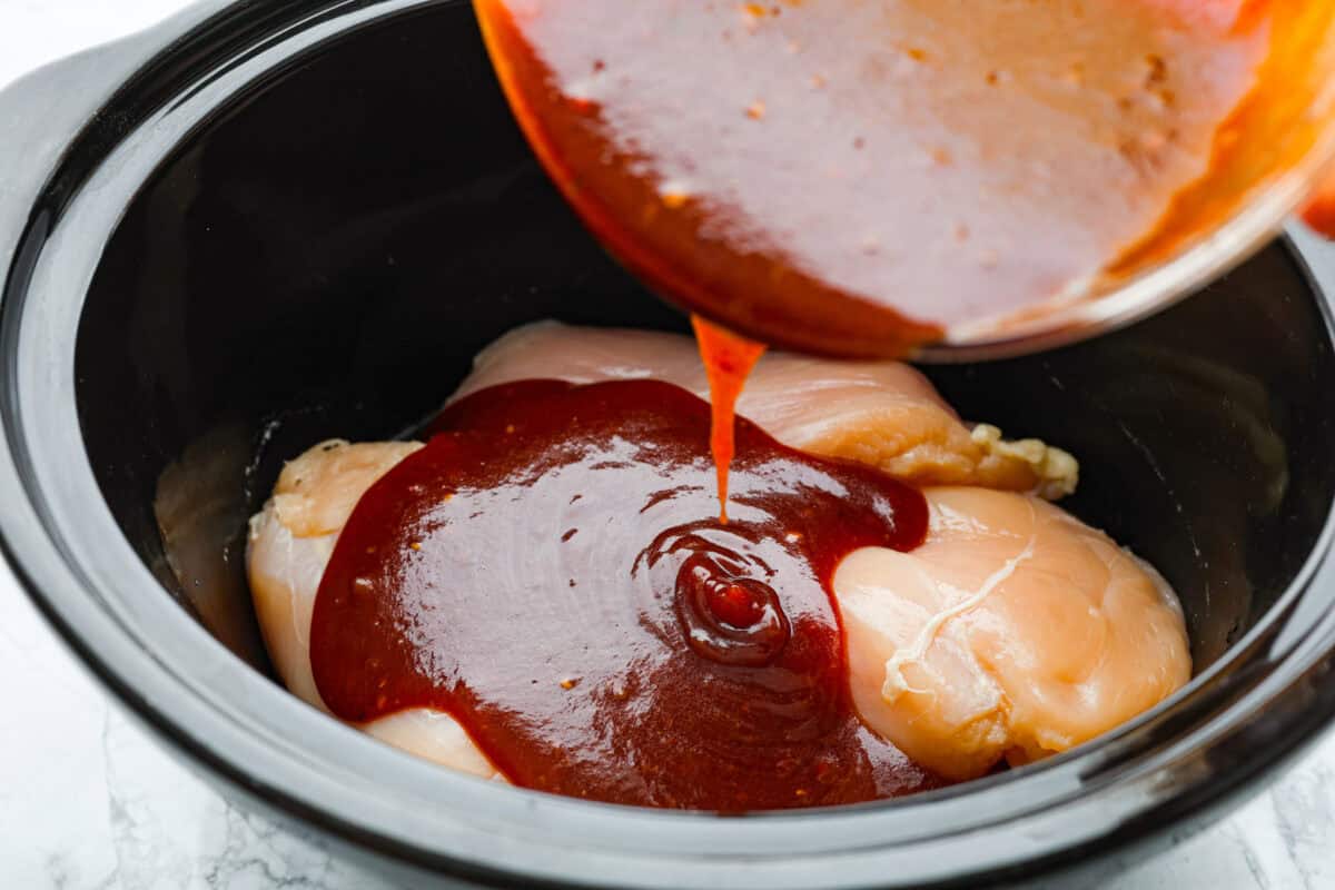 Fourth photo of the bbq sauce pouring over the chicken.