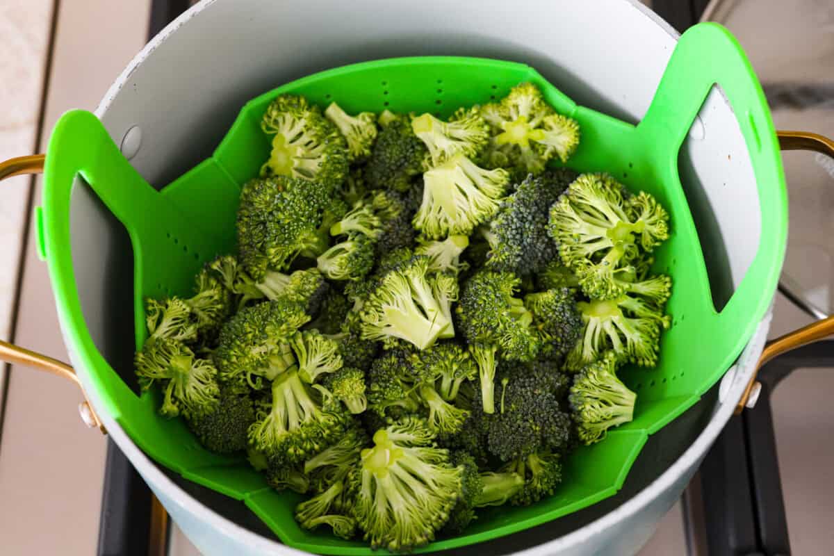 Overhead shot of broccoli in steamer in a pot. 