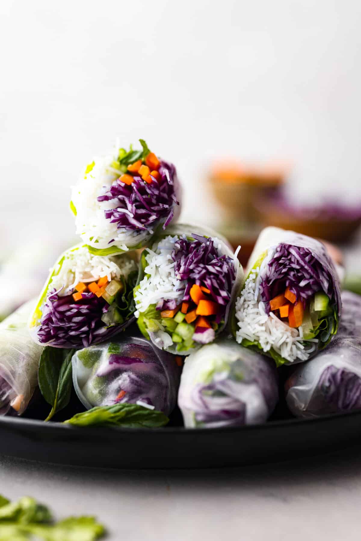 Stacked spring rolls on a plate. 