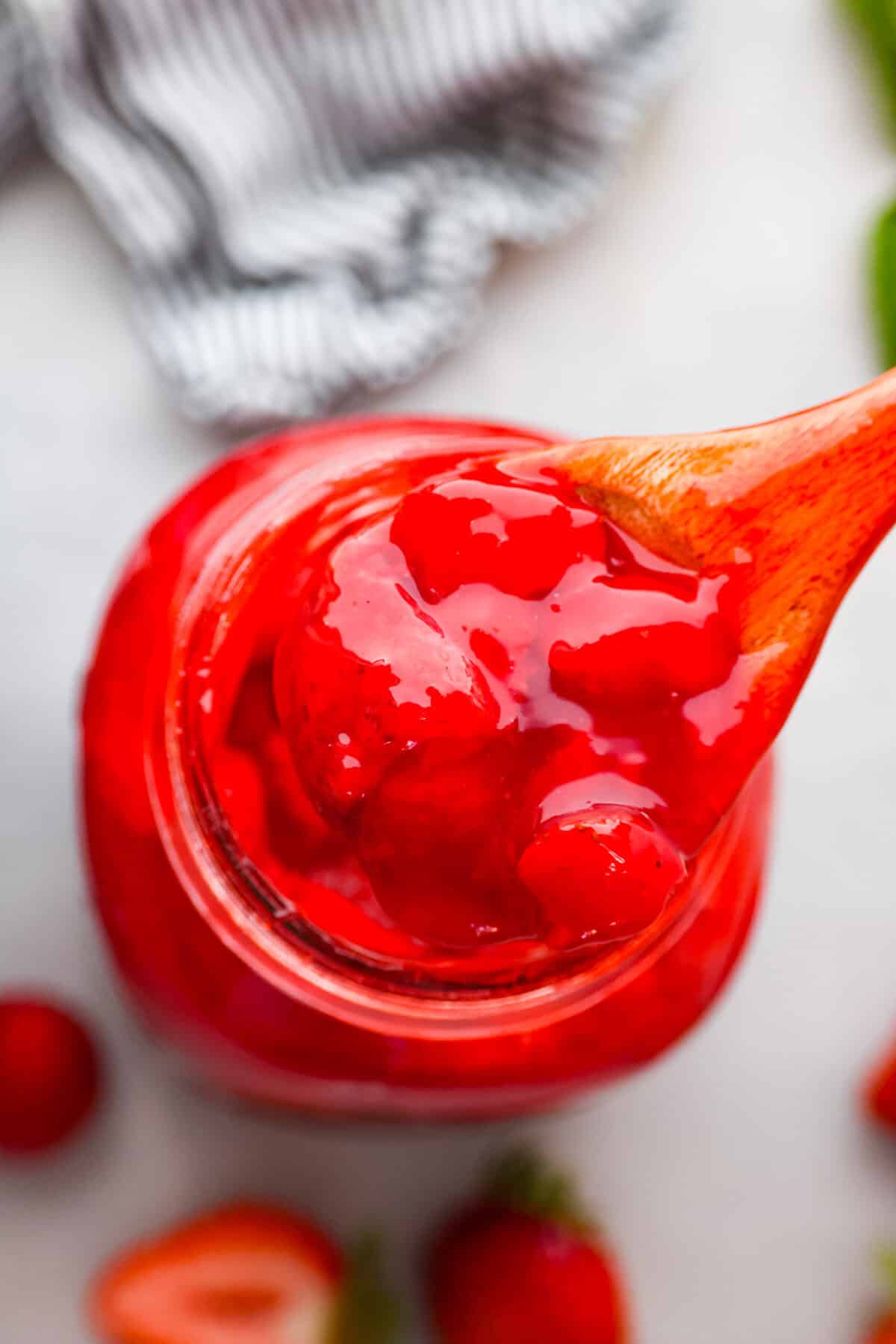 The top view of strawberry pie filling in a jar. 