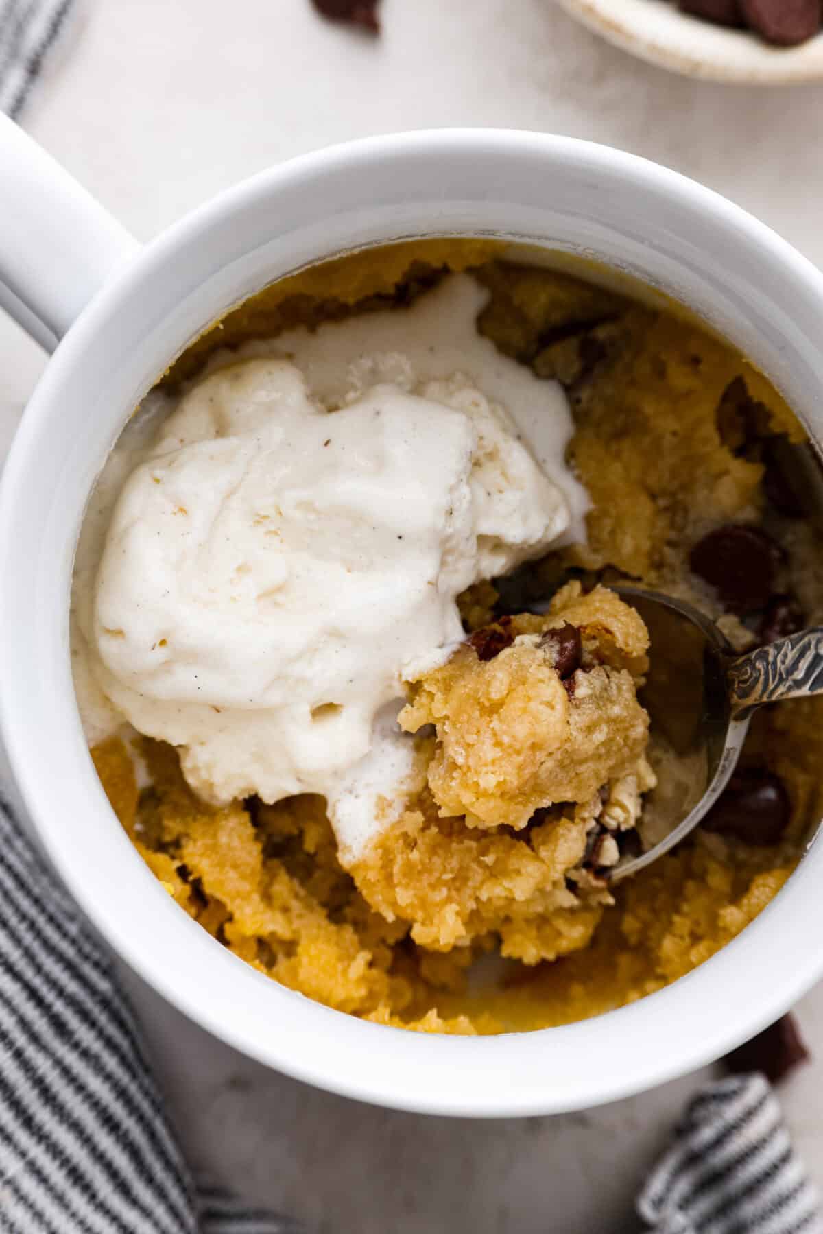 Close up shot of someone scooping a bite with a bit of ice cream with a spoon. 