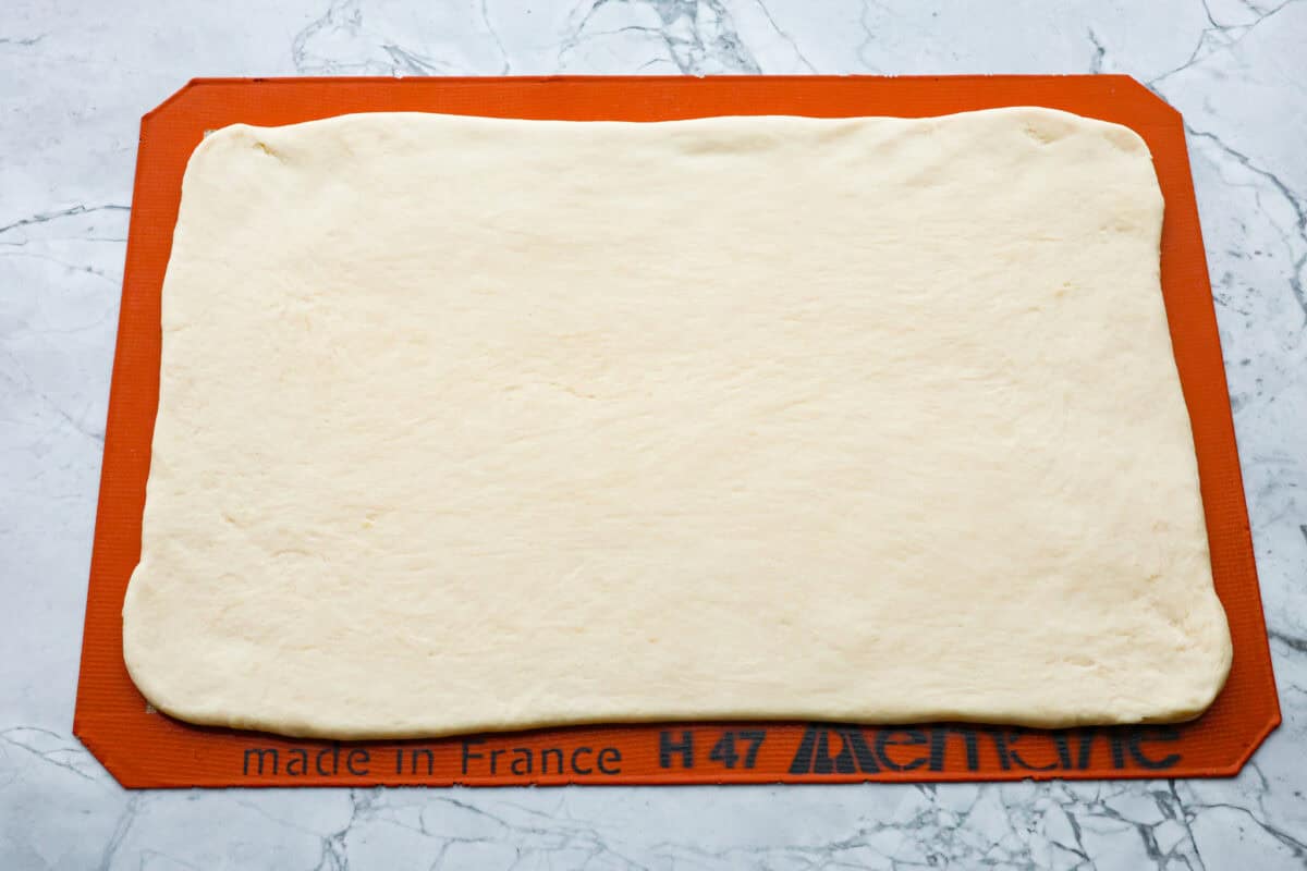 Overhead shot of dough pounded out into a 9x14 rectangle. 