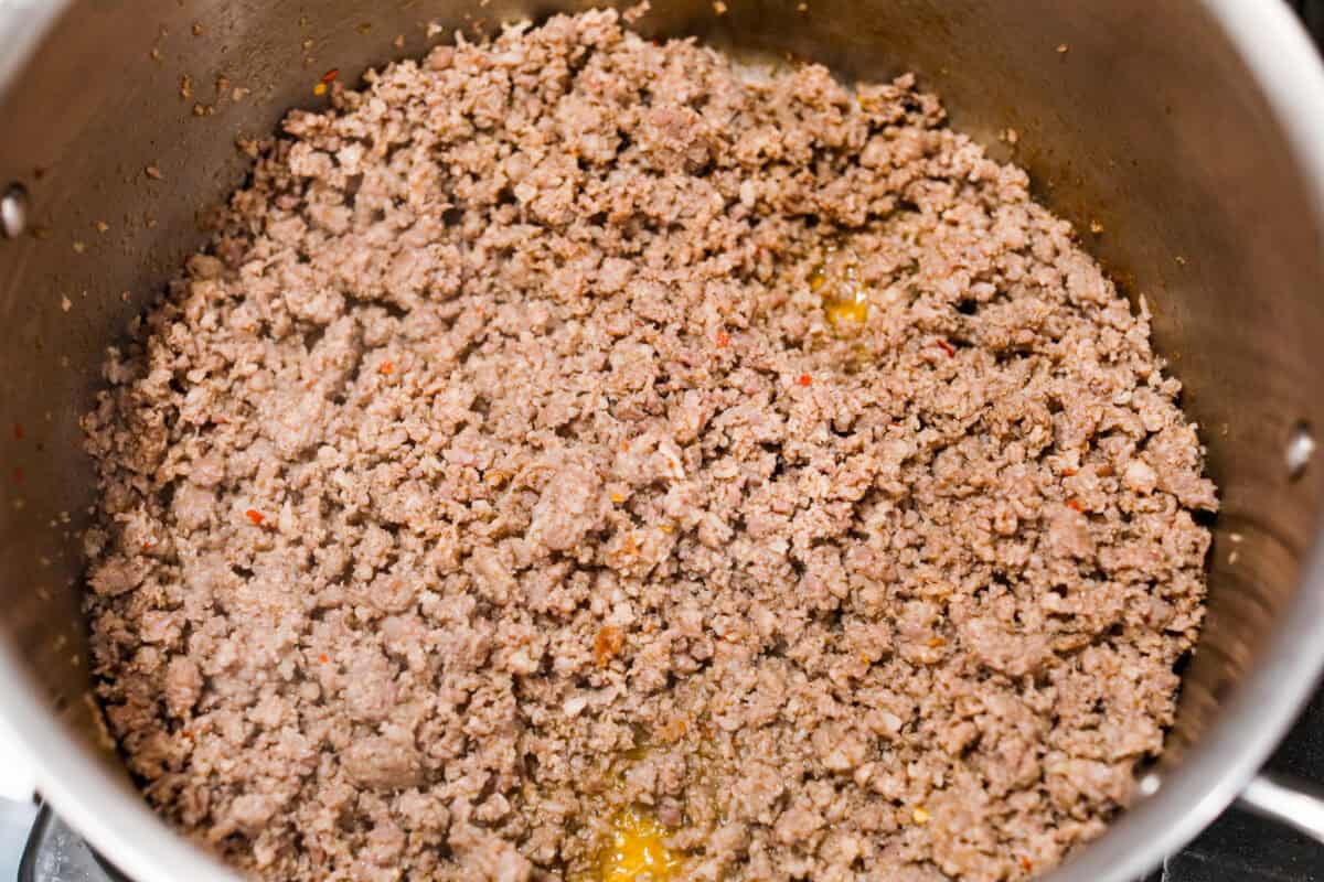 Overhead shot of sausage being cooked in a pan. 