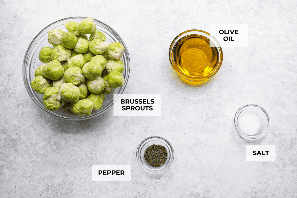 Irresistibly crispy Smashed Brussels Sprouts are simple to make, loaded with delicious flavor, and have the best crunchy texture. These pair well with almost any protein and will definitely upgrade your side dish game! Overhead shot of labeled ingredients.