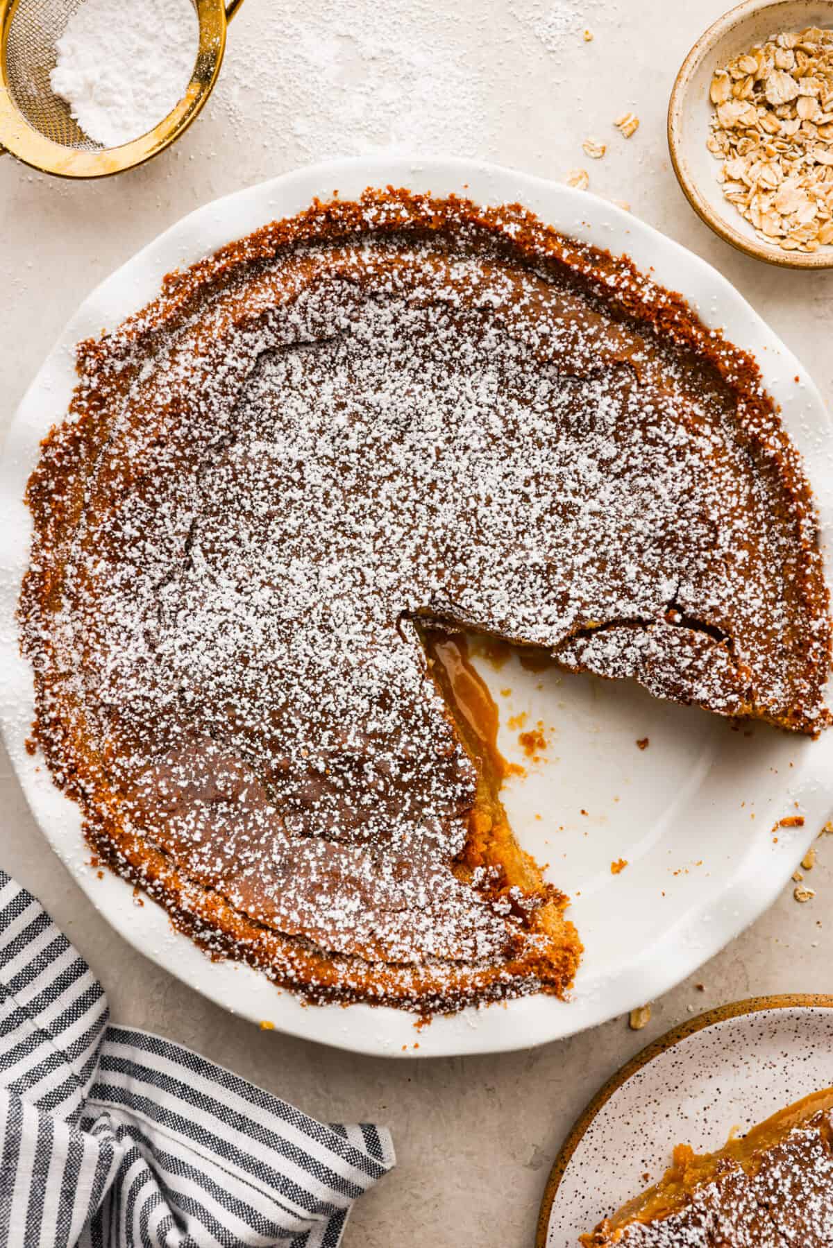 Overhead shot of baked crack pie with a dusting of powdered sugar over the top. 